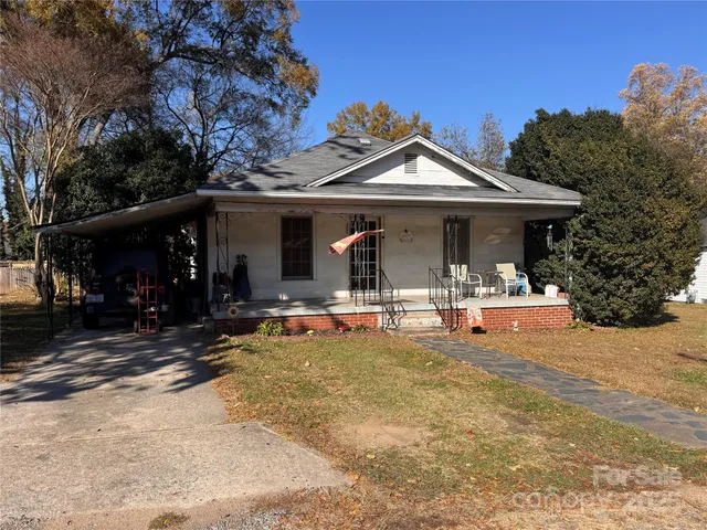a view of a house with yard and sitting area