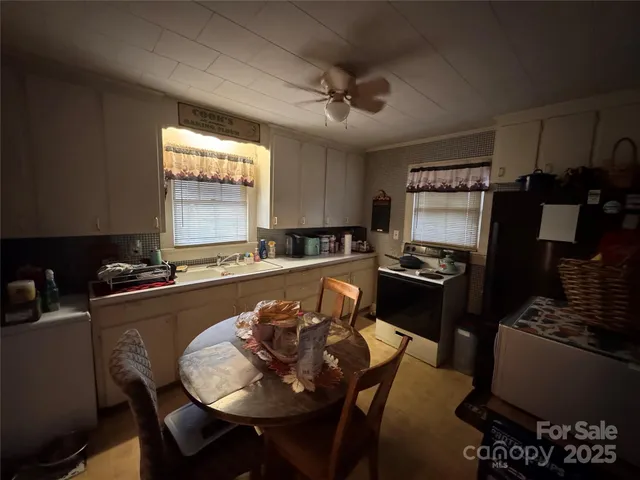 a kitchen with a refrigerator and a stove top oven