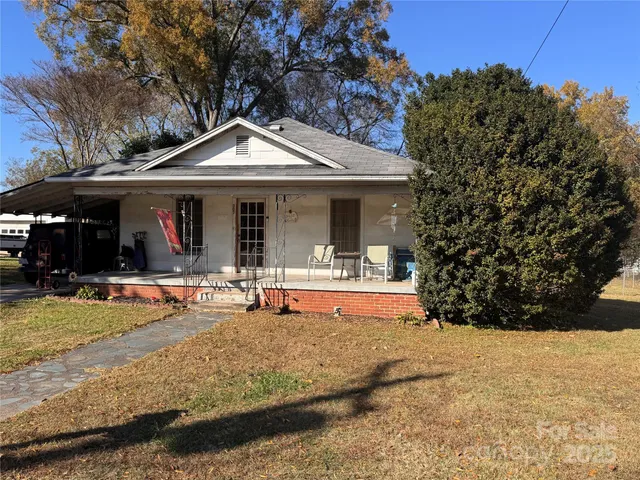 a view of a house with backyard porch and sitting area