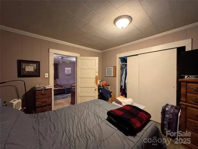 a bedroom with furniture and a flat screen tv