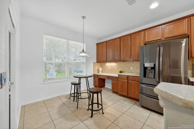 a kitchen with stainless steel appliances granite countertop a refrigerator and a stove top oven