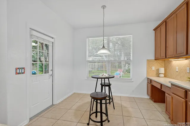 a kitchen with granite countertop a sink a counter top space and cabinets