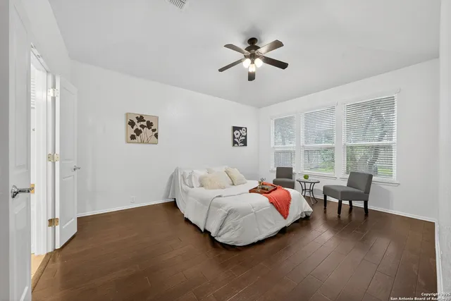 a bedroom with furniture and wooden floor