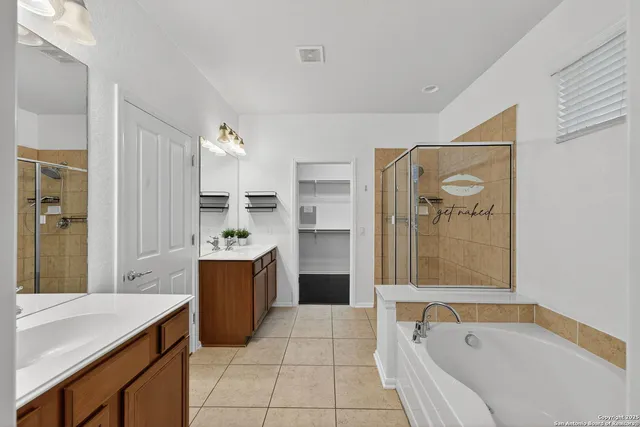 a large bathroom with a tub shower and sink