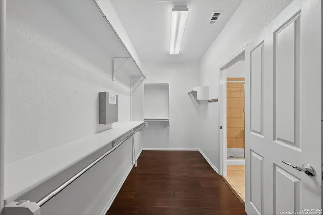 a view of a hallway with white walls and white walls