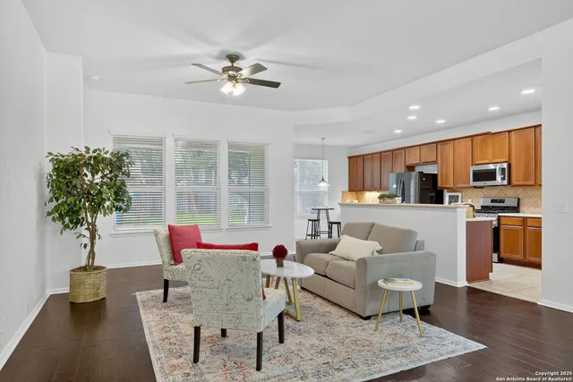 a living room with furniture and a potted plant