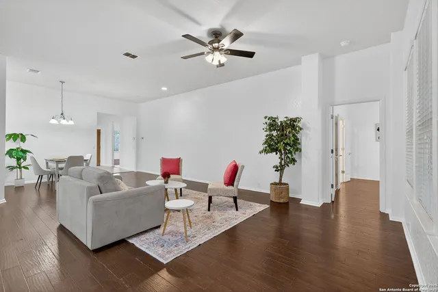 a living room with furniture and wooden floor