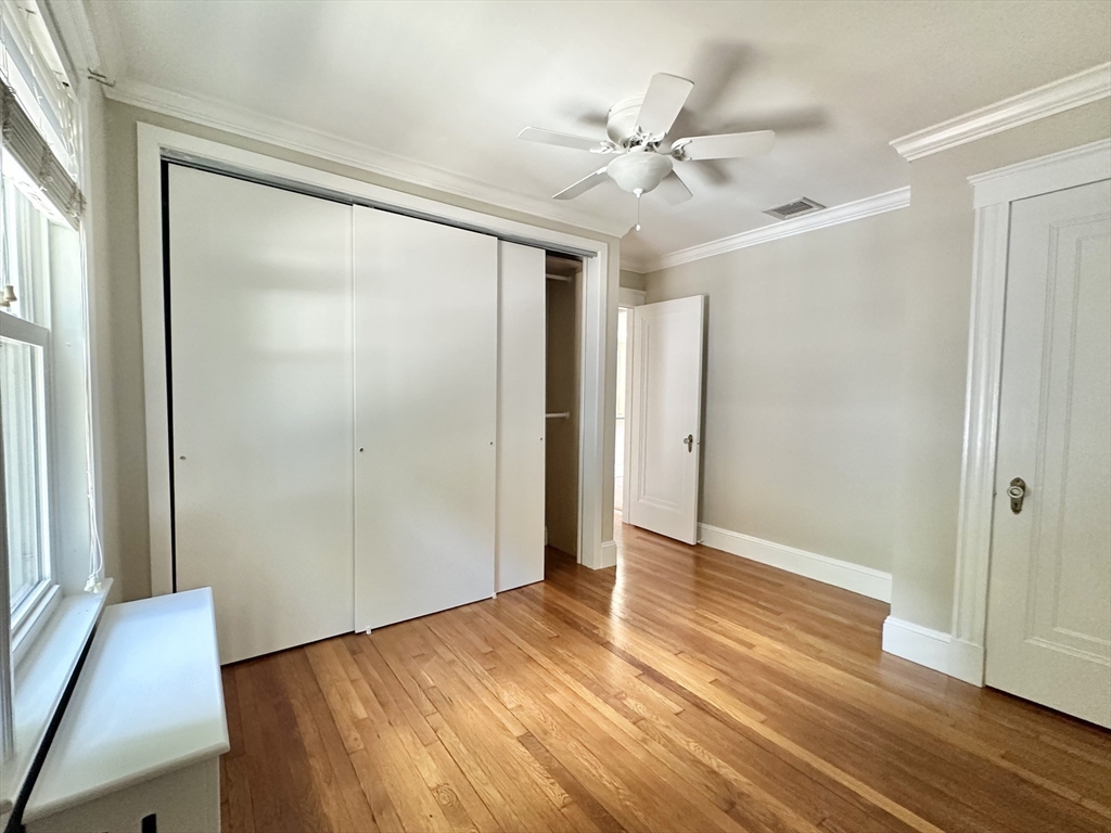8 A Mellon Road Wellesley, MA 02482 - Photo 8 of 22 an empty room with wooden floor fan and windows