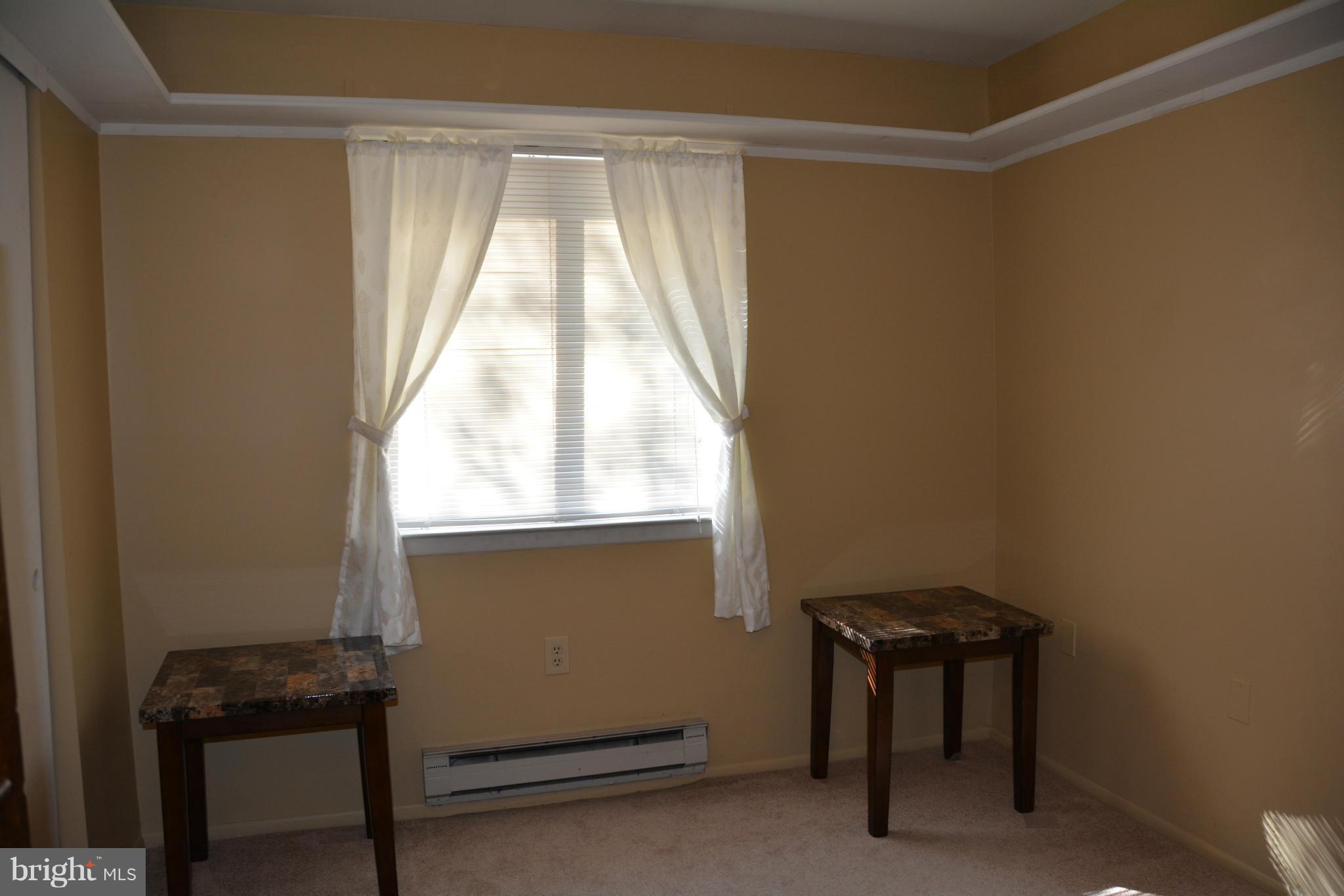 7004 Basswood Road Frederick, MD 21703 - Photo 9 of 16 a room that has a window and a table in it
