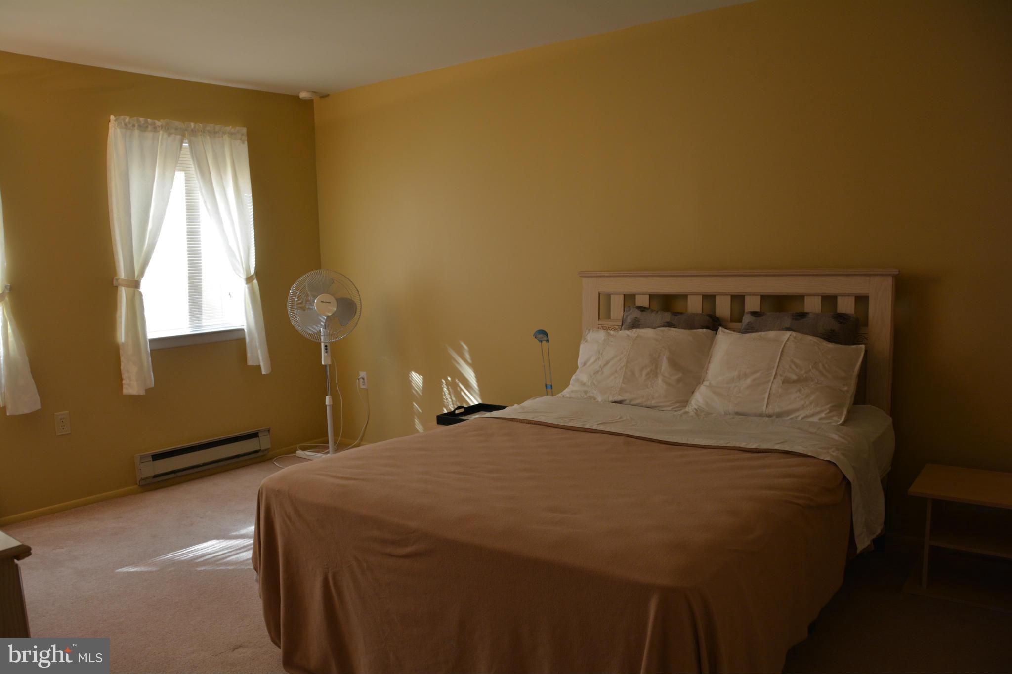 7004 Basswood Road Frederick, MD 21703 - Photo 10 of 16 a bedroom with a bed and window