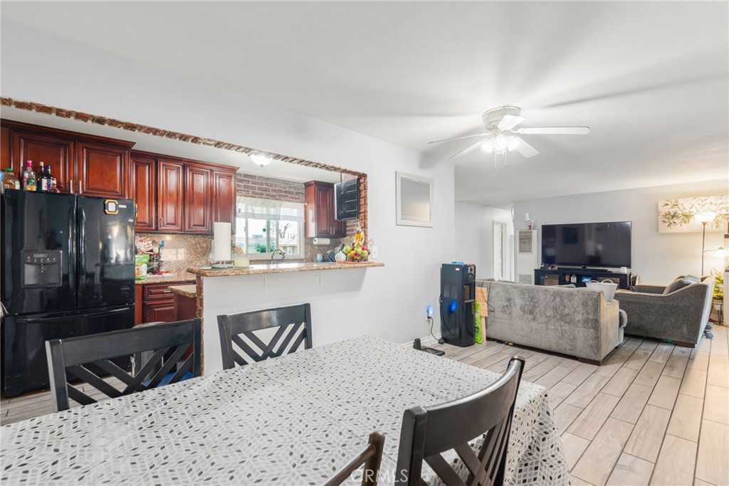 19450 Woodhill Street Rialto, CA 92376 - Photo 15 of 51 a kitchen with kitchen island a dining table and chairs