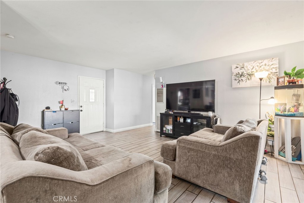 19450 Woodhill Street Rialto, CA 92376 - Photo 20 of 51 a living room with furniture and a flat screen tv