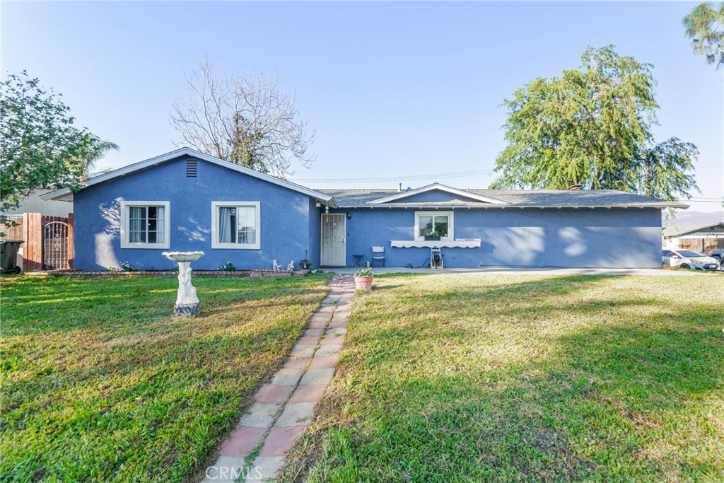 19450 Woodhill Street Rialto, CA 92376 - Photo 2 of 51 a front view of a house with a yard