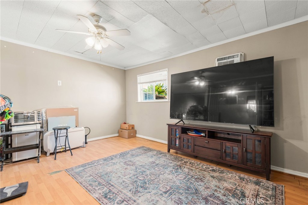 19450 Woodhill Street Rialto, CA 92376 - Photo 22 of 51 a living room with furniture and a flat screen tv