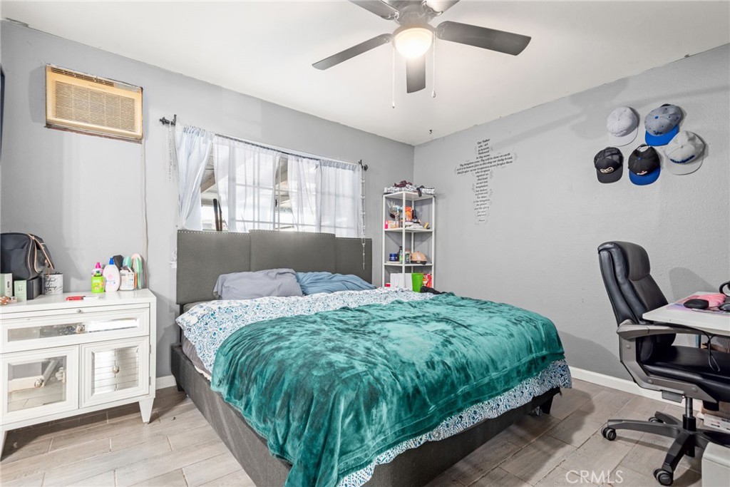 19450 Woodhill Street Rialto, CA 92376 - Photo 24 of 51 a bedroom with a bed wall painting and a window