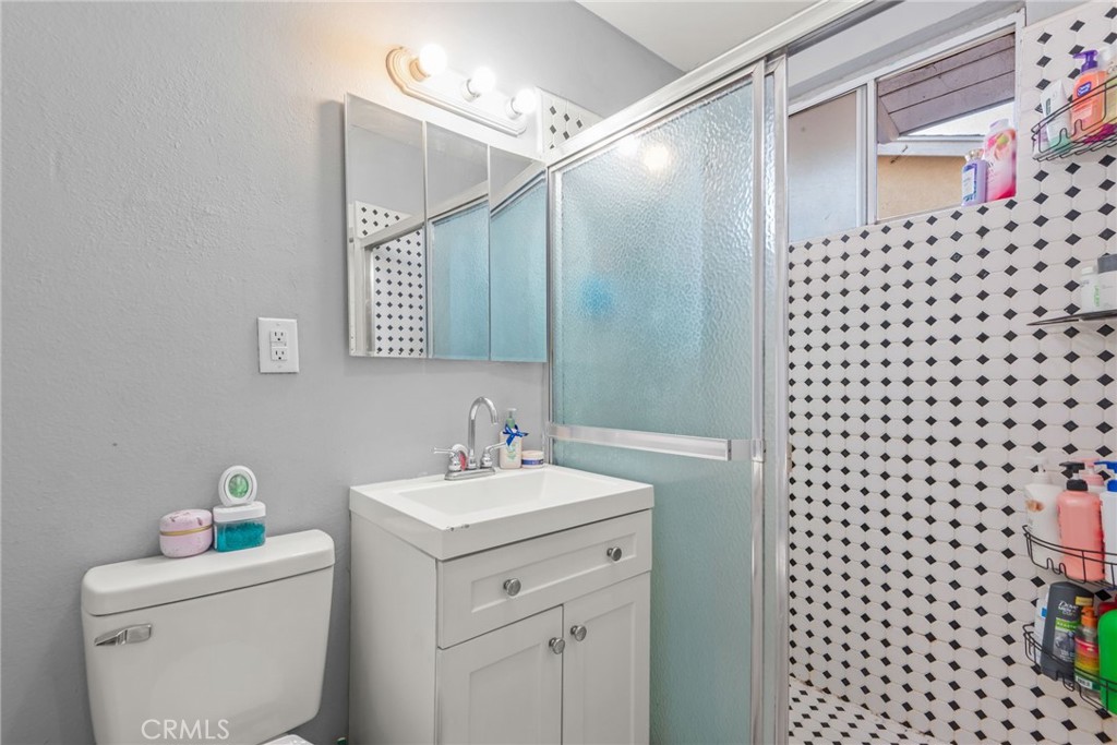 19450 Woodhill Street Rialto, CA 92376 - Photo 28 of 51 a bathroom with a sink a toilet and a shower