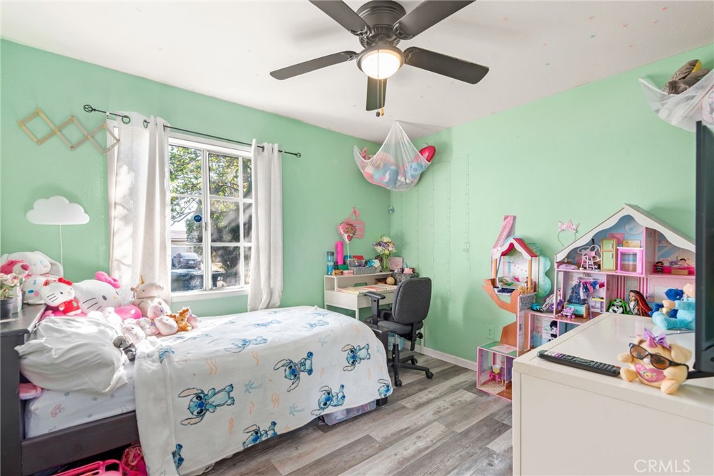 19450 Woodhill Street Rialto, CA 92376 - Photo 29 of 51 a bedroom with a bed and a chandelier