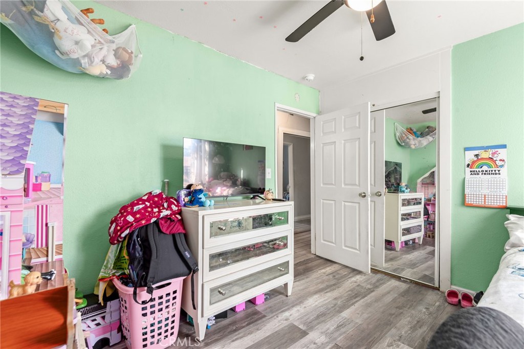 19450 Woodhill Street Rialto, CA 92376 - Photo 30 of 51 a bedroom with furniture and a flat screen tv