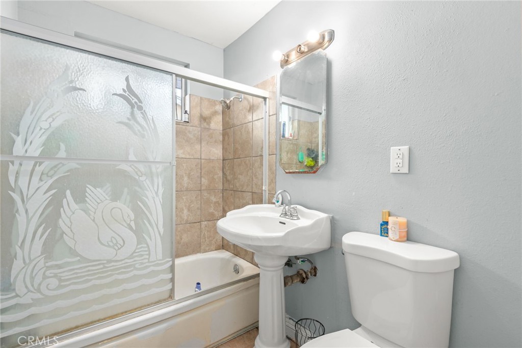 19450 Woodhill Street Rialto, CA 92376 - Photo 31 of 51 a bathroom with a sink a toilet and shower