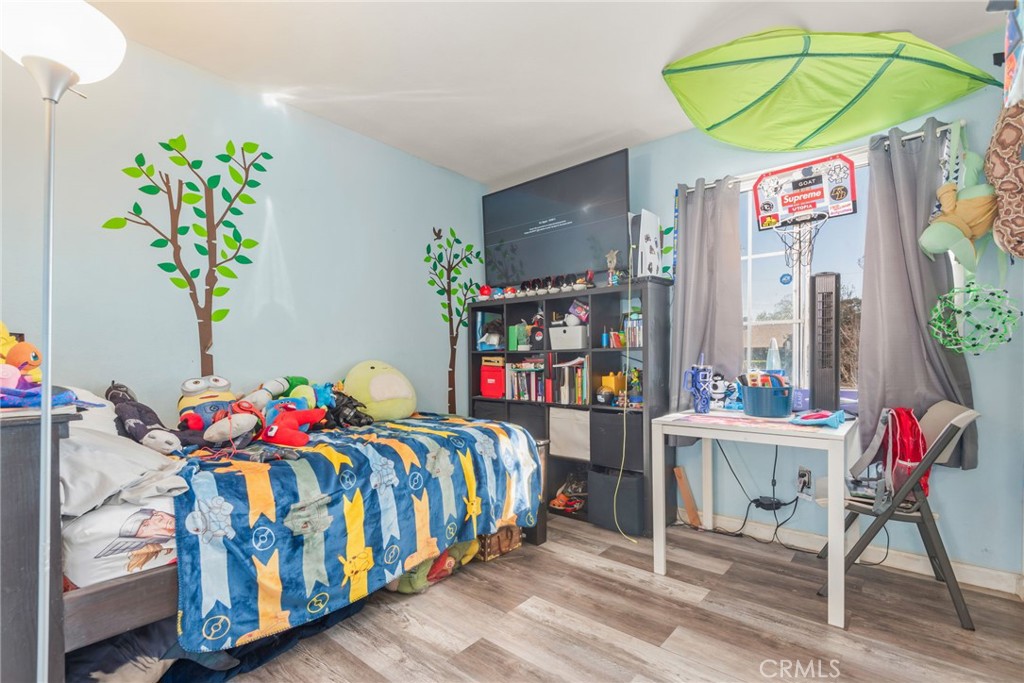 19450 Woodhill Street Rialto, CA 92376 - Photo 32 of 51 a bedroom with a bed and a table