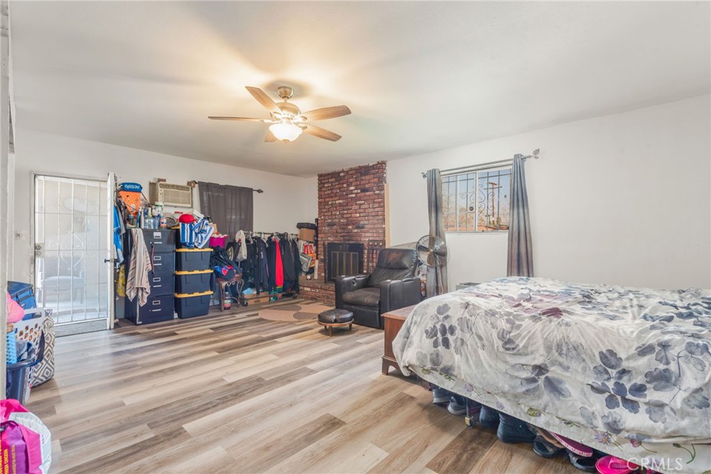 19450 Woodhill Street Rialto, CA 92376 - Photo 34 of 51 a bedroom with bed and a chandelier