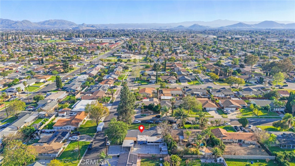 19450 Woodhill Street Rialto, CA 92376 - Photo 49 of 51 an aerial view of residential houses with city and mountain view in back