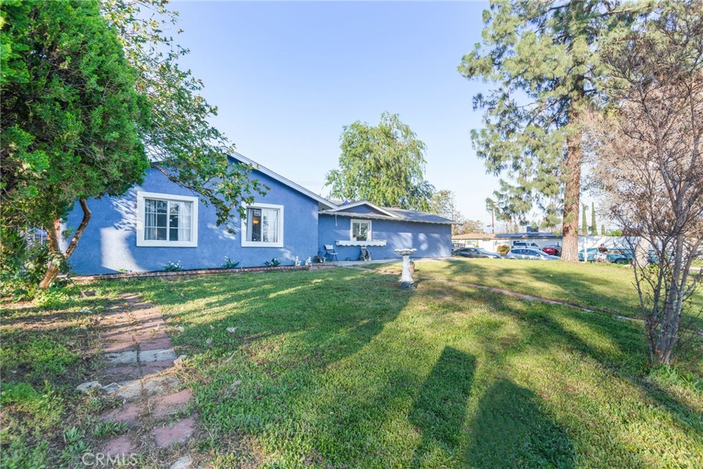 19450 Woodhill Street Rialto, CA 92376 - Photo 6 of 51 a view of a house with a yard