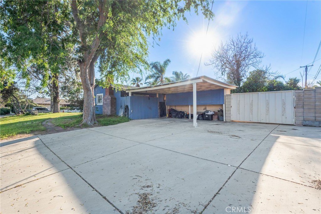 19450 Woodhill Street Rialto, CA 92376 - Photo 8 of 51 a view of a house with a yard and large tree
