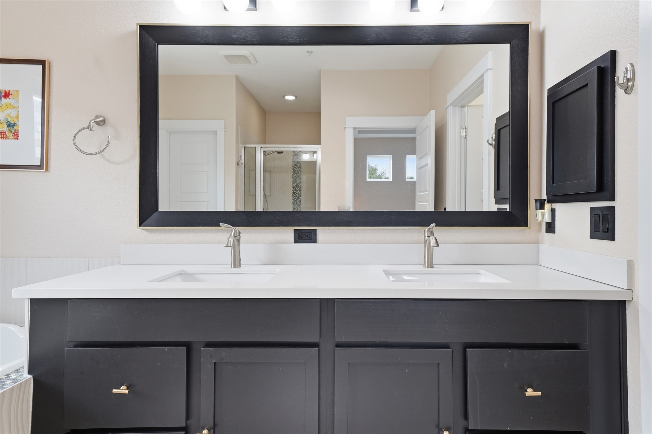 3901 Vaughan Street Austin, TX 78723 - Photo 22 of 37 Double vanity with white countertop, dual undermount sinks, and brushed nickel faucets