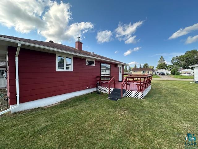 30 Fir Circle Babbitt, MN 55706 - Photo 27 of 27 Rear view of property featuring a wooden deck, a lawn, and a chimney