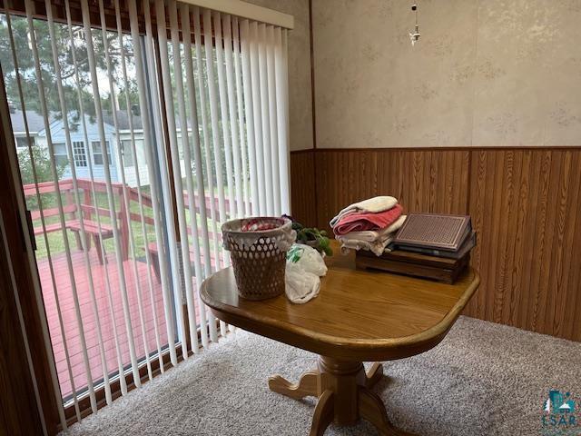 30 Fir Circle Babbitt, MN 55706 - Photo 10 of 27 Carpeted dining space featuring a wainscoted wall, wallpapered walls, and wooden walls