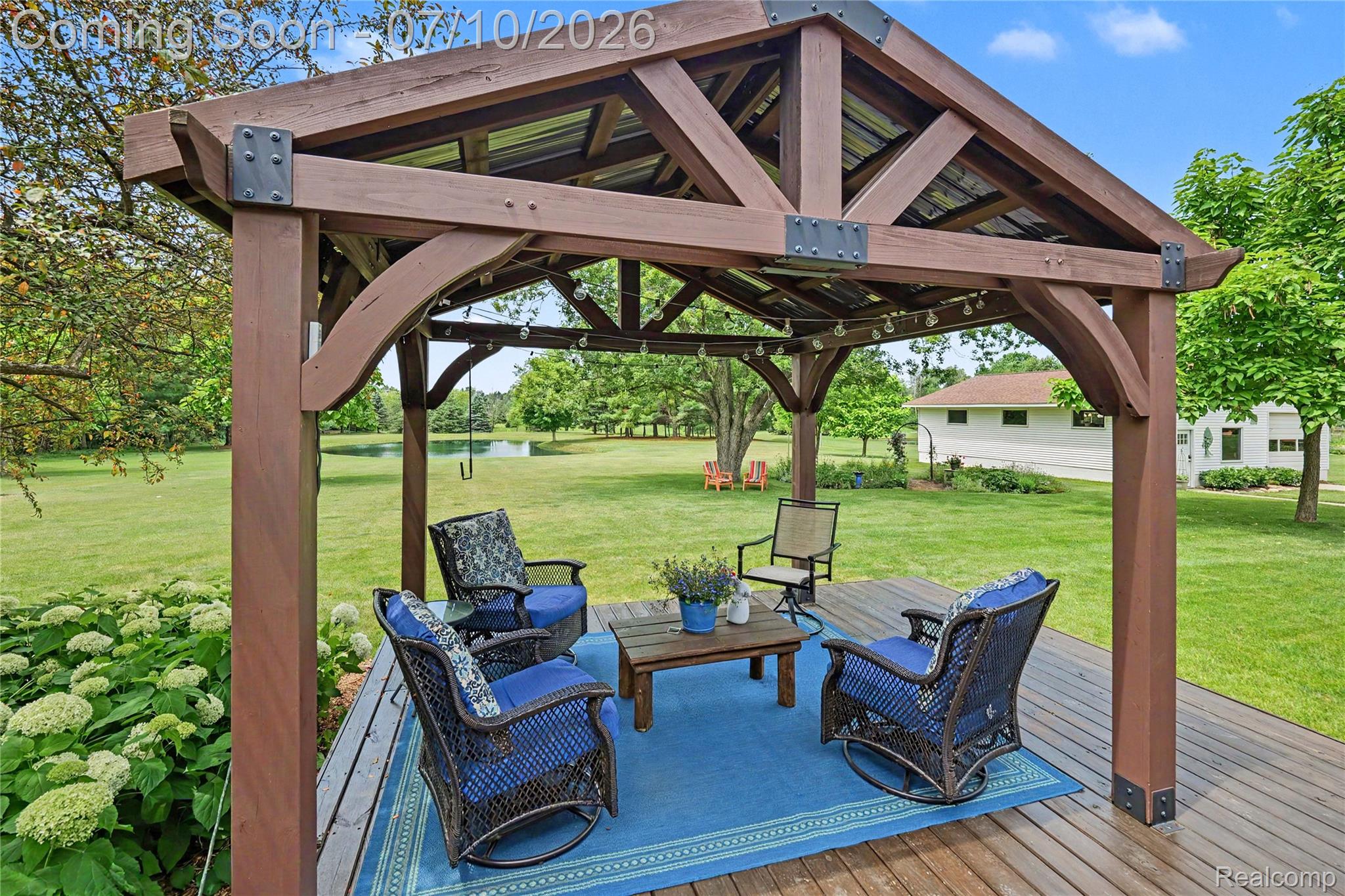 2180 Hurst Road St. Clair, MI 48079 - Photo 29 of 39 Spacious outdoor gazebo with a metal roof and exposed wooden beams, situated on a composite deck