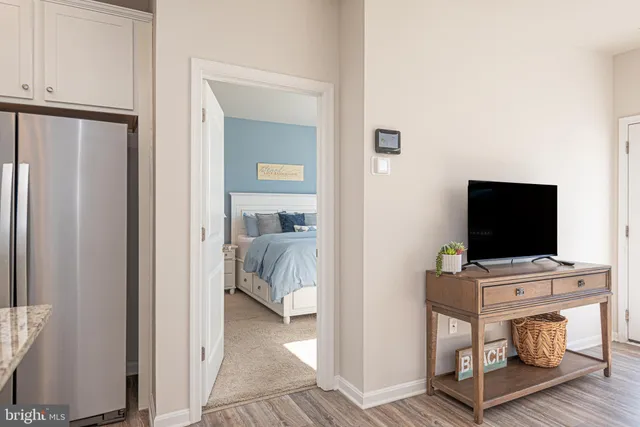 a en suite bathroom with a granite countertop sink and a mirror