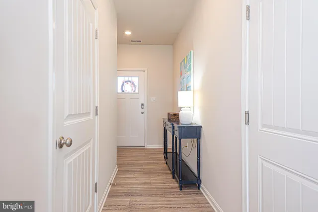 a kitchen with a dining table chairs refrigerator and microwave