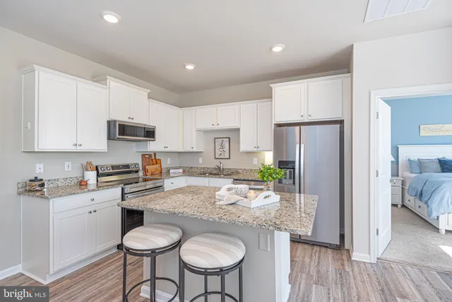 a living room with furniture a window and wooden floor