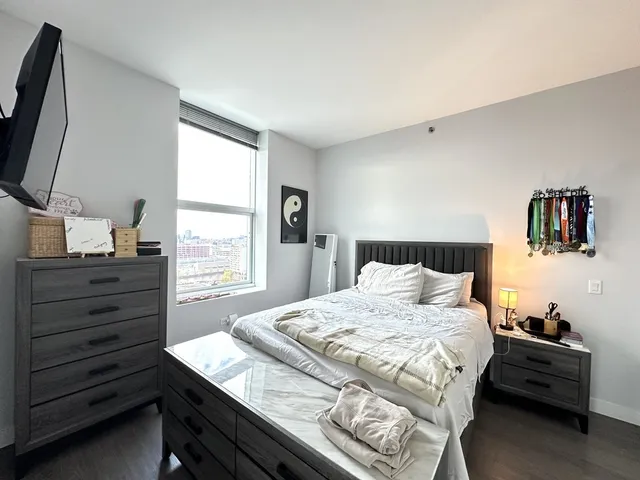 a bedroom with a bed and a window