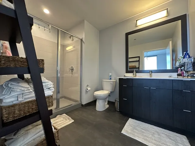 a bathroom with a toilet a sink and a mirror