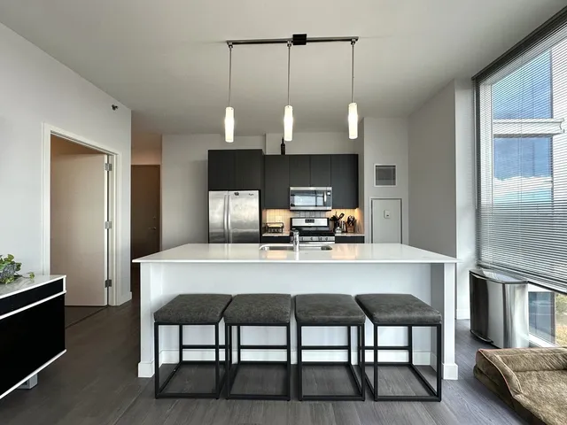 a dining room with furniture and wooden floor
