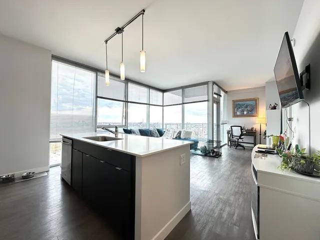 a kitchen with sink cabinets and wooden floor