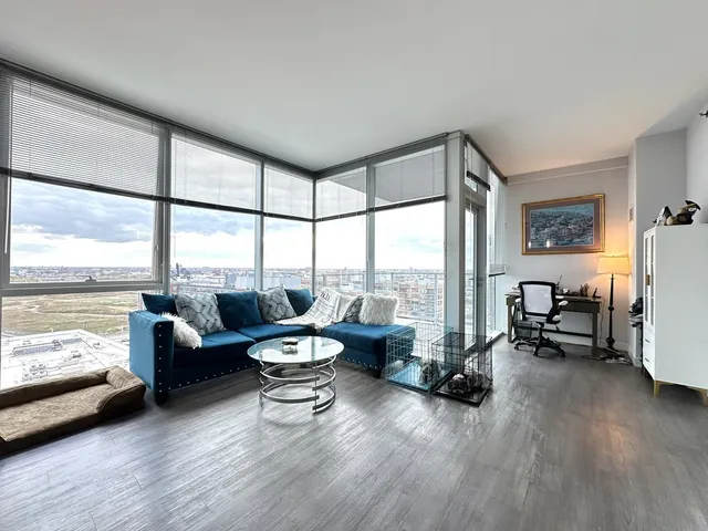 a living room with furniture and floor to ceiling window