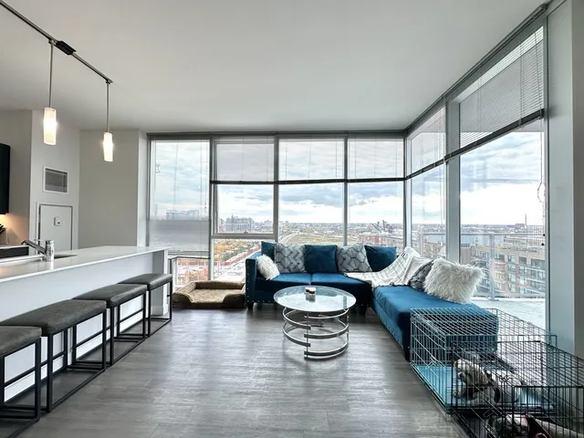 a living room with furniture and large windows
