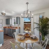 a view of a dining room with furniture a livingroom and chandelier