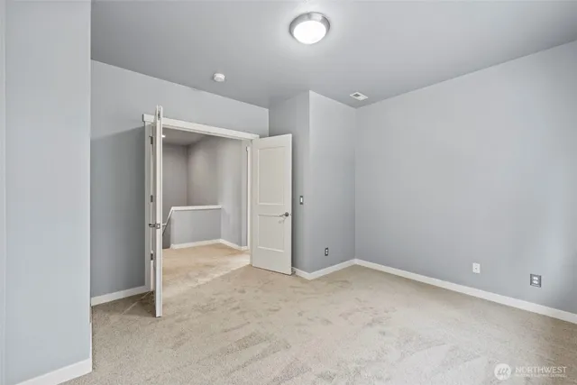 an empty room with closet and a window