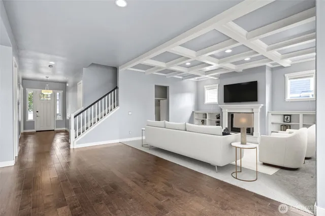 a spacious bedroom with a bed and a fireplace with television