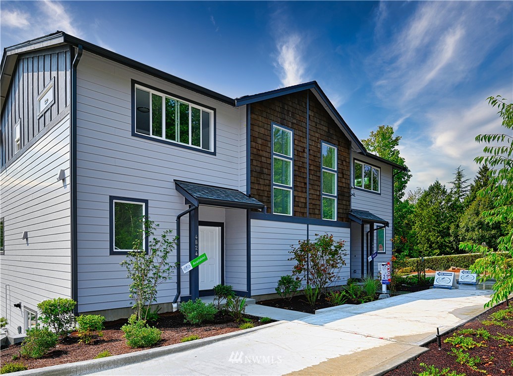 4831 Talbot Road South, Unit A1 Renton, WA 98055 - Photo 1 of 40 a front view of a house with garden