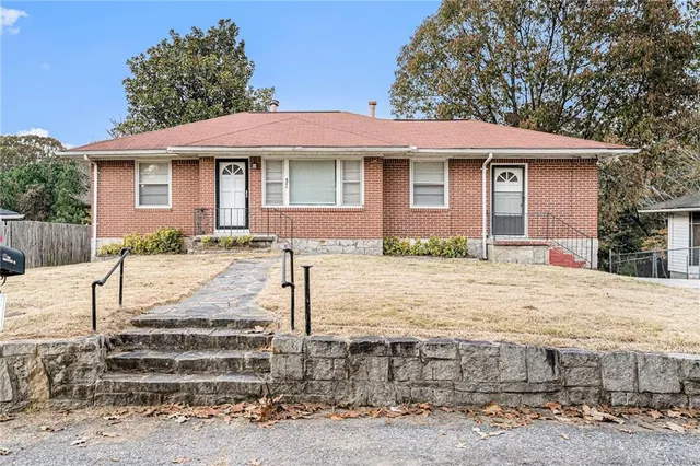 a front view of a house with garden