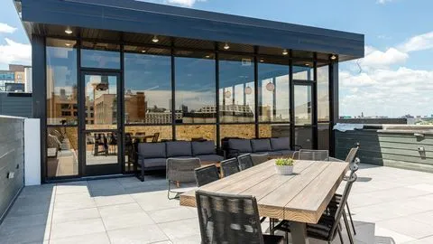 a terrace with outdoor seating and city view