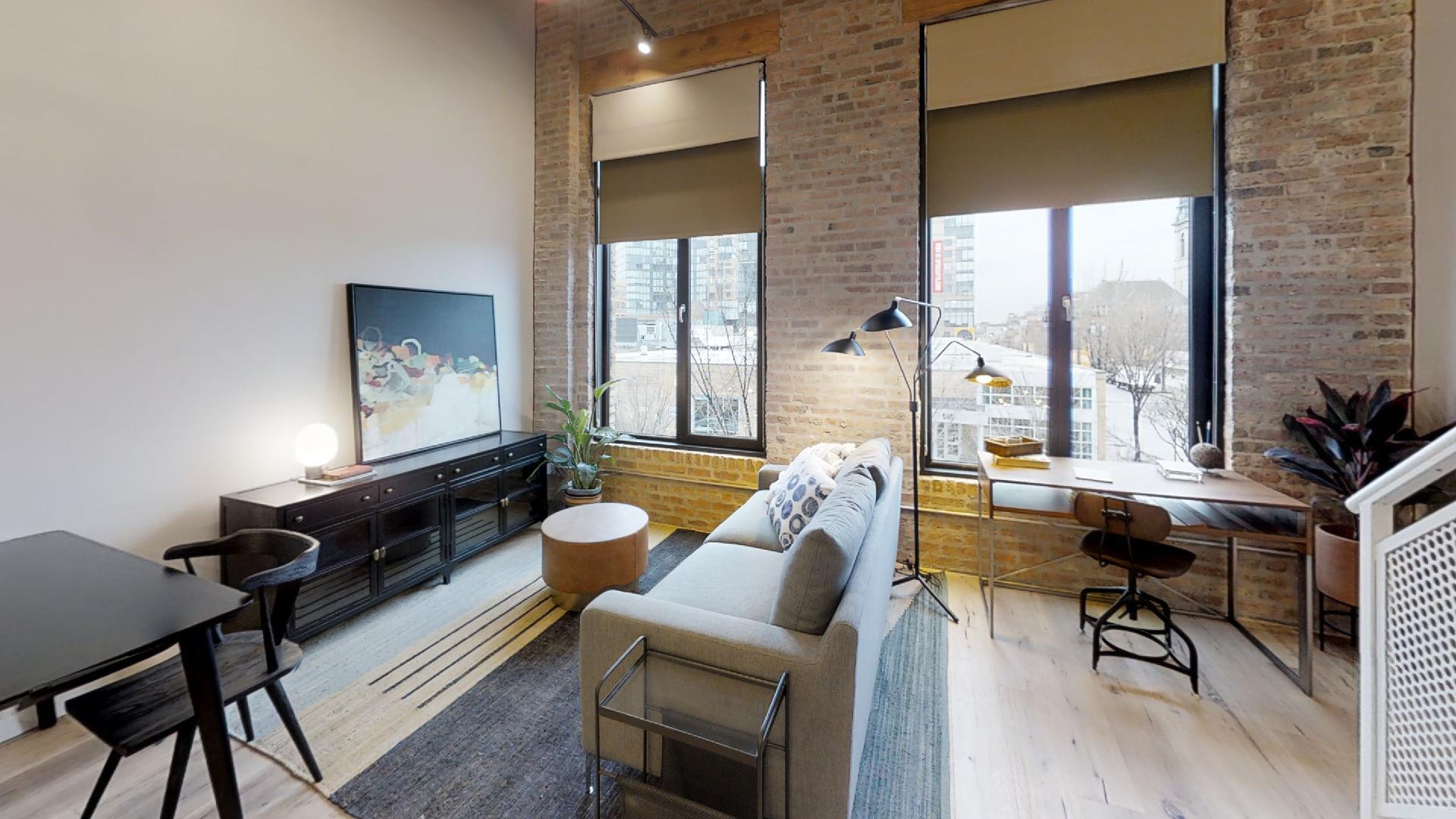 729 North Sangamon Street, Unit 303 Chicago, IL 60642 - Photo 5 of 16 a living room with furniture and a large window