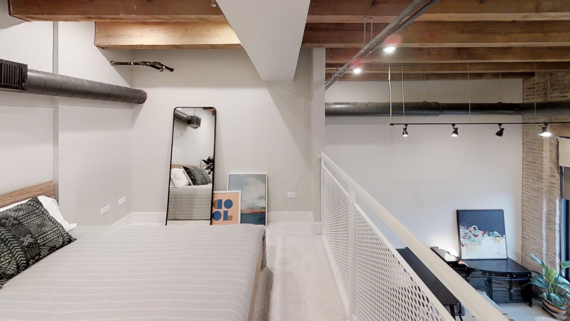 729 North Sangamon Street, Unit 303 Chicago, IL 60642 - Photo 7 of 16 a bedroom with a bed and a ceiling fan