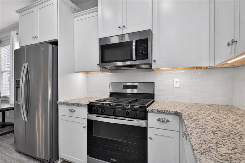 24 Teton Trail Jasper, GA 30143 - Photo 16 of 41 a kitchen with stainless steel appliances white cabinets and a stove top oven